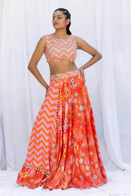 Orange kilim printed lehengas with chevron choli