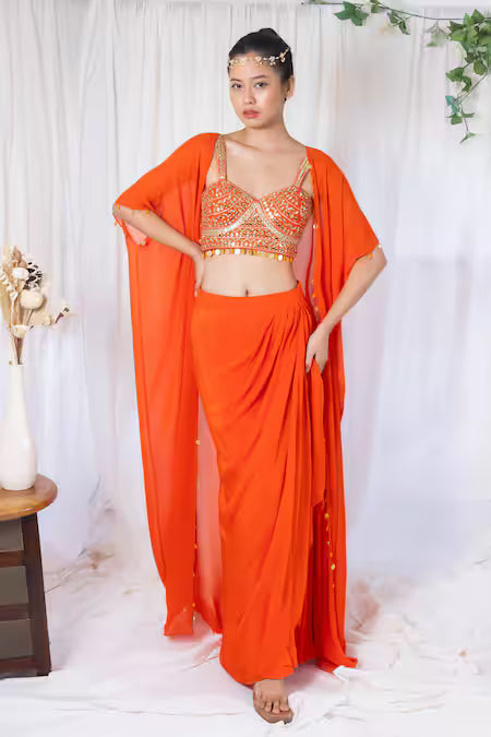 Orange draped saree with mirror work choli and cape