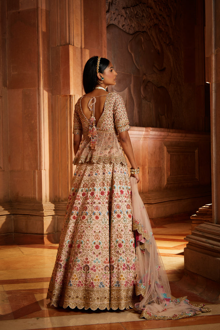 Blush Pink Raw Silk Lehenga with a Peplum Top and Tulle Dupatta