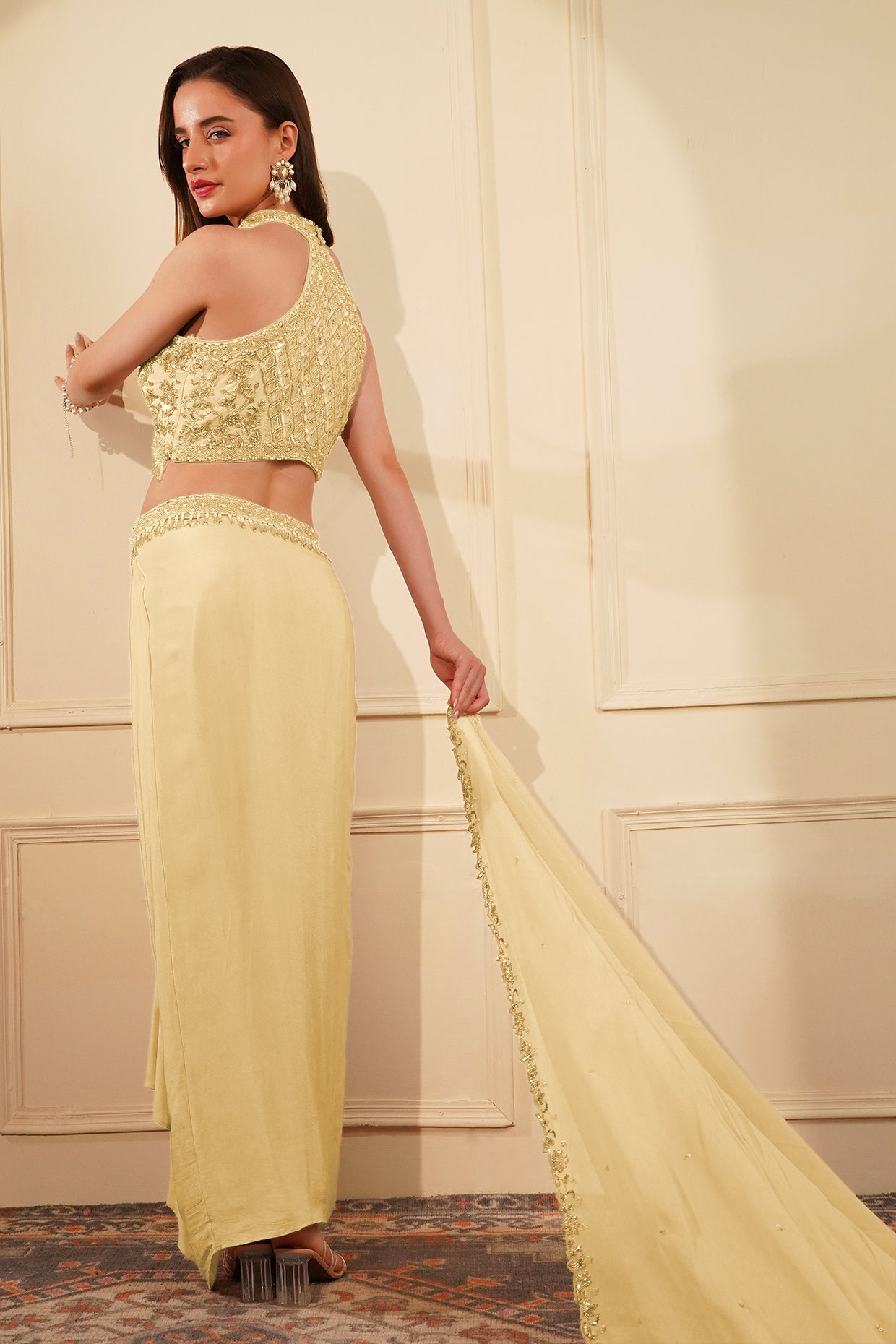 Cream Colour Crepe Drape Skirt Set With Heavy Hand Embroidered Halter Blouse And Dupatta