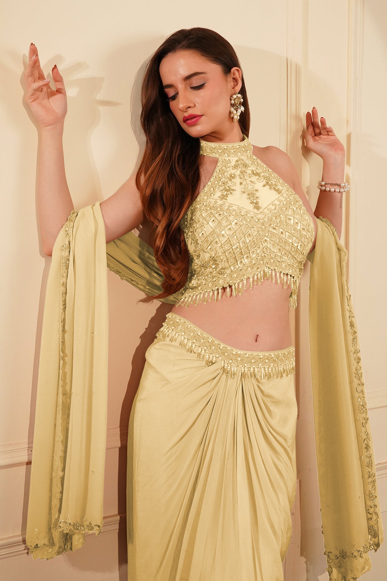 Cream Colour Crepe Drape Skirt Set With Heavy Hand Embroidered Halter Blouse And Dupatta