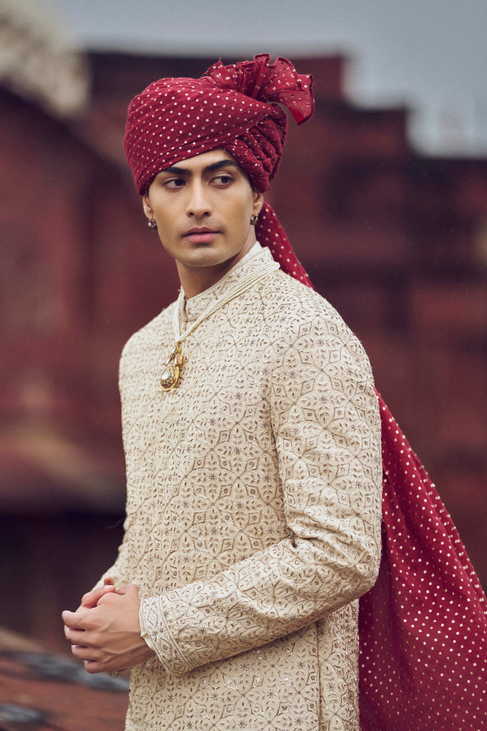 LIGHT BEIGE RAW SILK SHERWANI WITH KURTA AND CHURIDAR. IT COMES WITH AN OPTIONAL BELT, STOLE AND JUTIS