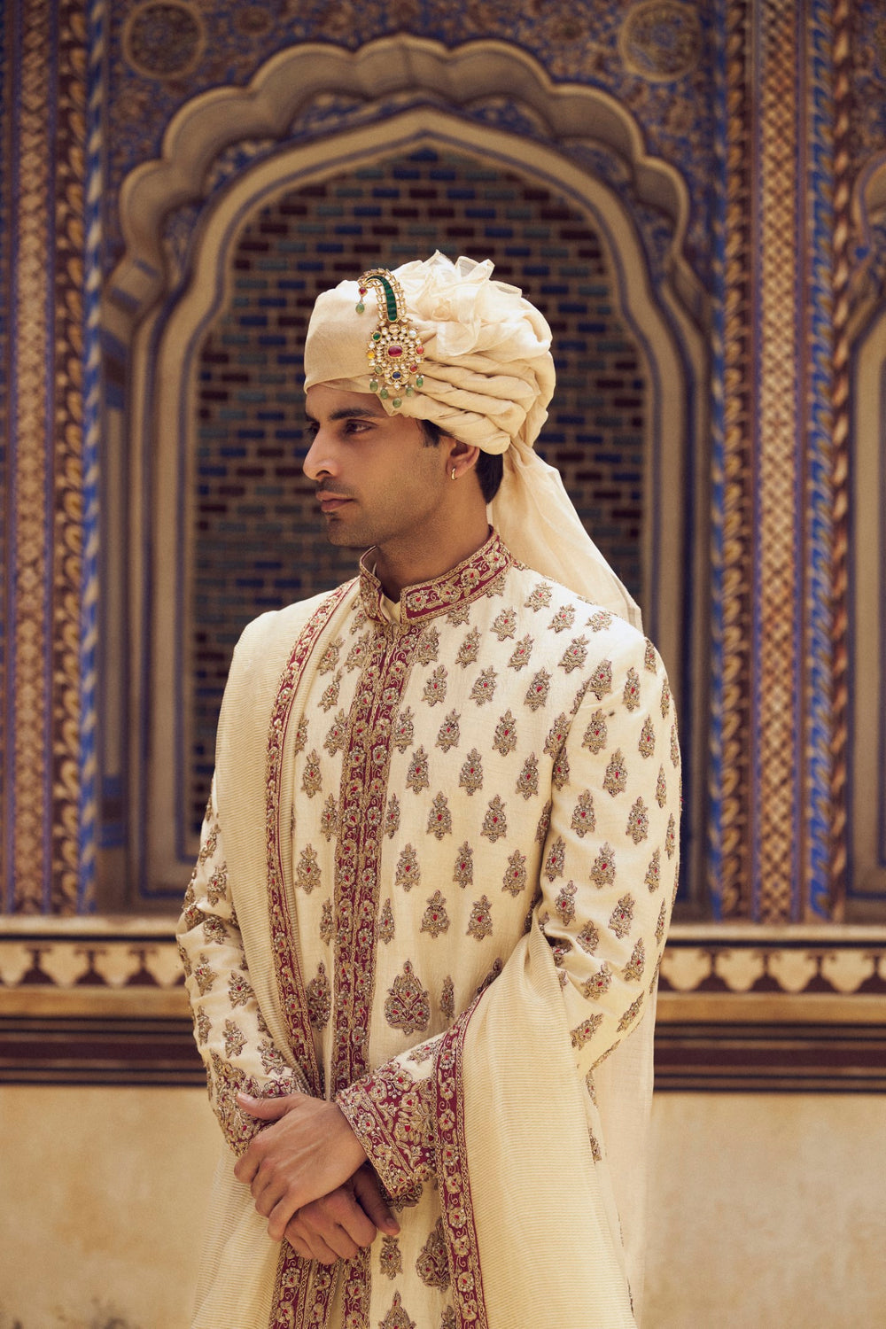 BEIGE RAW SILK SHERWANI WITH A COTTON SILK CHOGA AND CHURIDAR, WITH AN OPTIONAL STOLE AND JUTIS