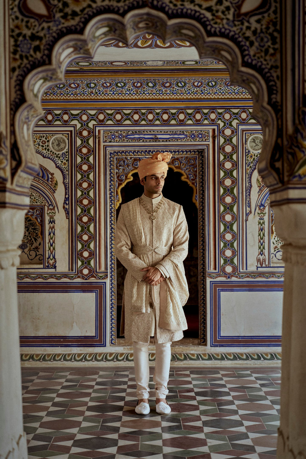 MUSHROOM RAW SILK SHERWANI WITH A COTTON SILK KURTA AND CHURIDAR AND OPTIONAL STOLE BELT AND WORKED JUTIS.