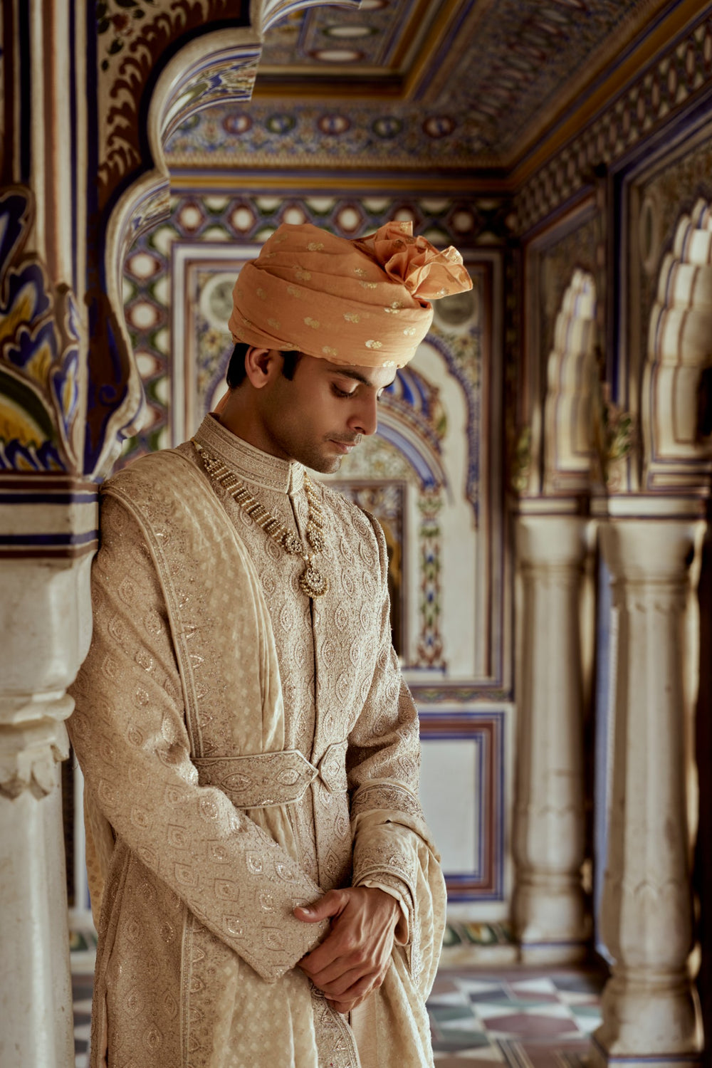 MUSHROOM RAW SILK SHERWANI WITH A COTTON SILK KURTA AND CHURIDAR AND OPTIONAL STOLE BELT AND WORKED JUTIS.