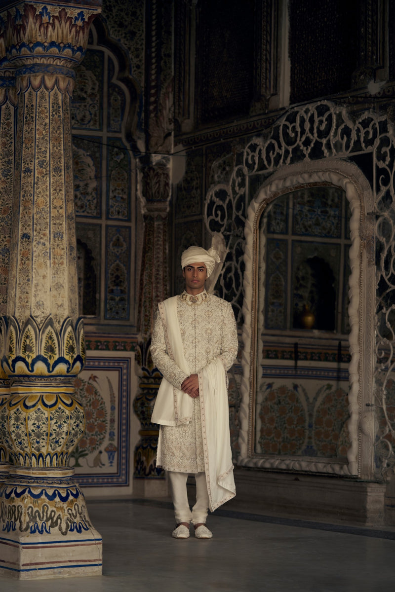 PEACH RAW SILK SHERWANI WITH KURTA AND TROUSER WITH AN OPTIONAL WORKED STOLE, BELT AND JUTIS