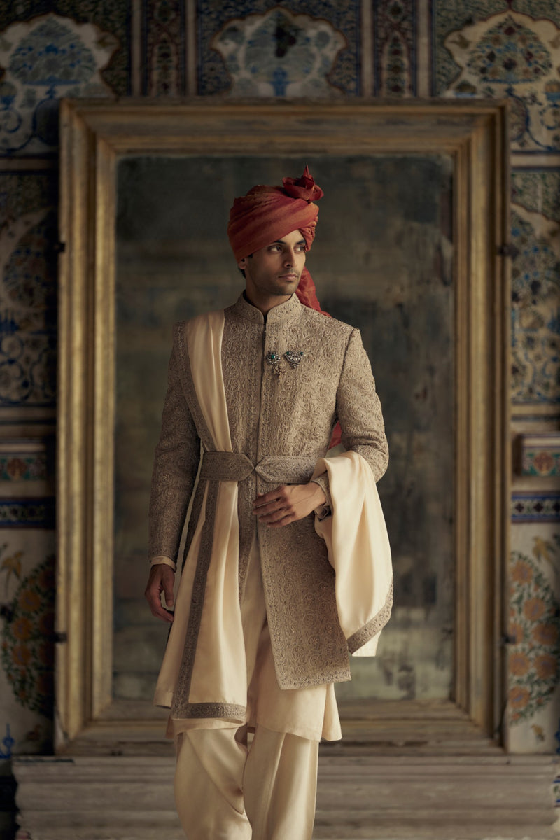 MOCCA RAW SILK SHERWANI WITH KURTA AND CHURIDAR. IT COMES WITH AN OPTIONAL WORKED STOLE, BELT AND JUTTIS