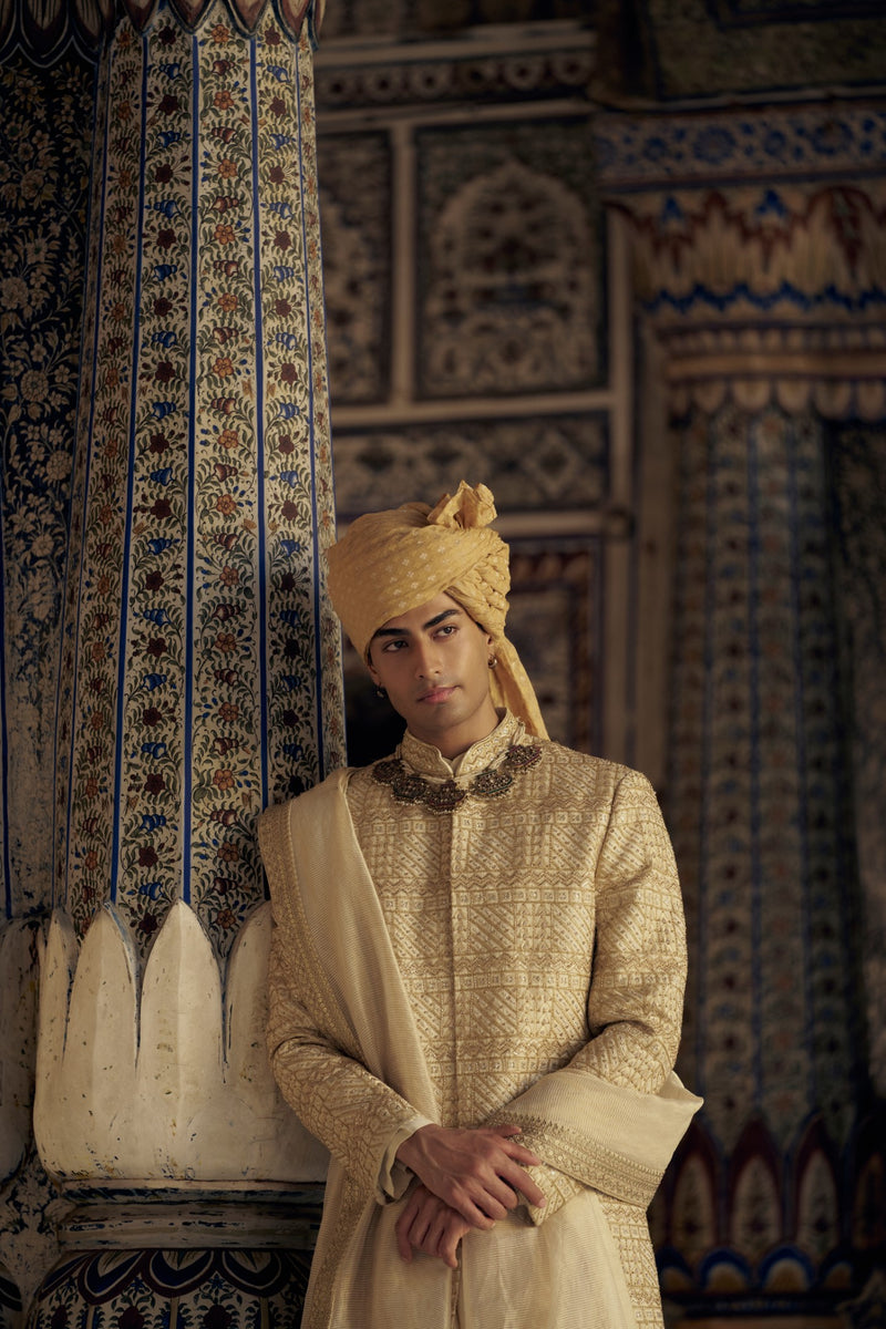GOLD SHERWANI SET WITH CHOGA AND CHURIDAR WHICH COMES WITH AN OPTIONAL WORKED STOLE AND JUTIS