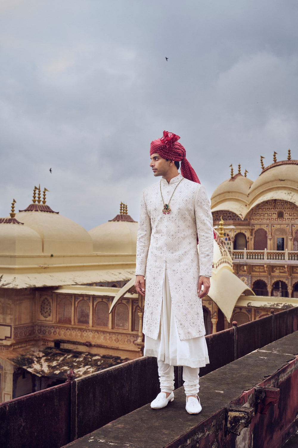 IVORY RAW SILK SHERWANI WITH A COTTON SILK CHOGA AND CHURIDAR AND OPTIONAL STOLE BELT AND WORKED JUTI