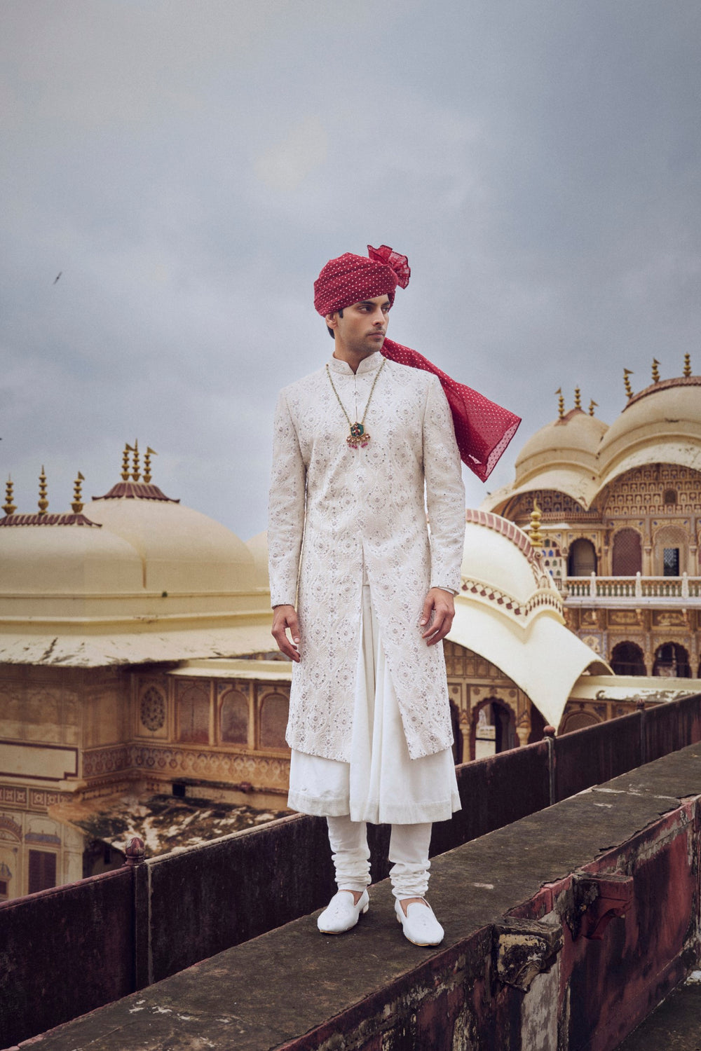 IVORY RAW SILK SHERWANI WITH A COTTON SILK CHOGA AND CHURIDAR AND OPTIONAL STOLE BELT AND WORKED JUTI