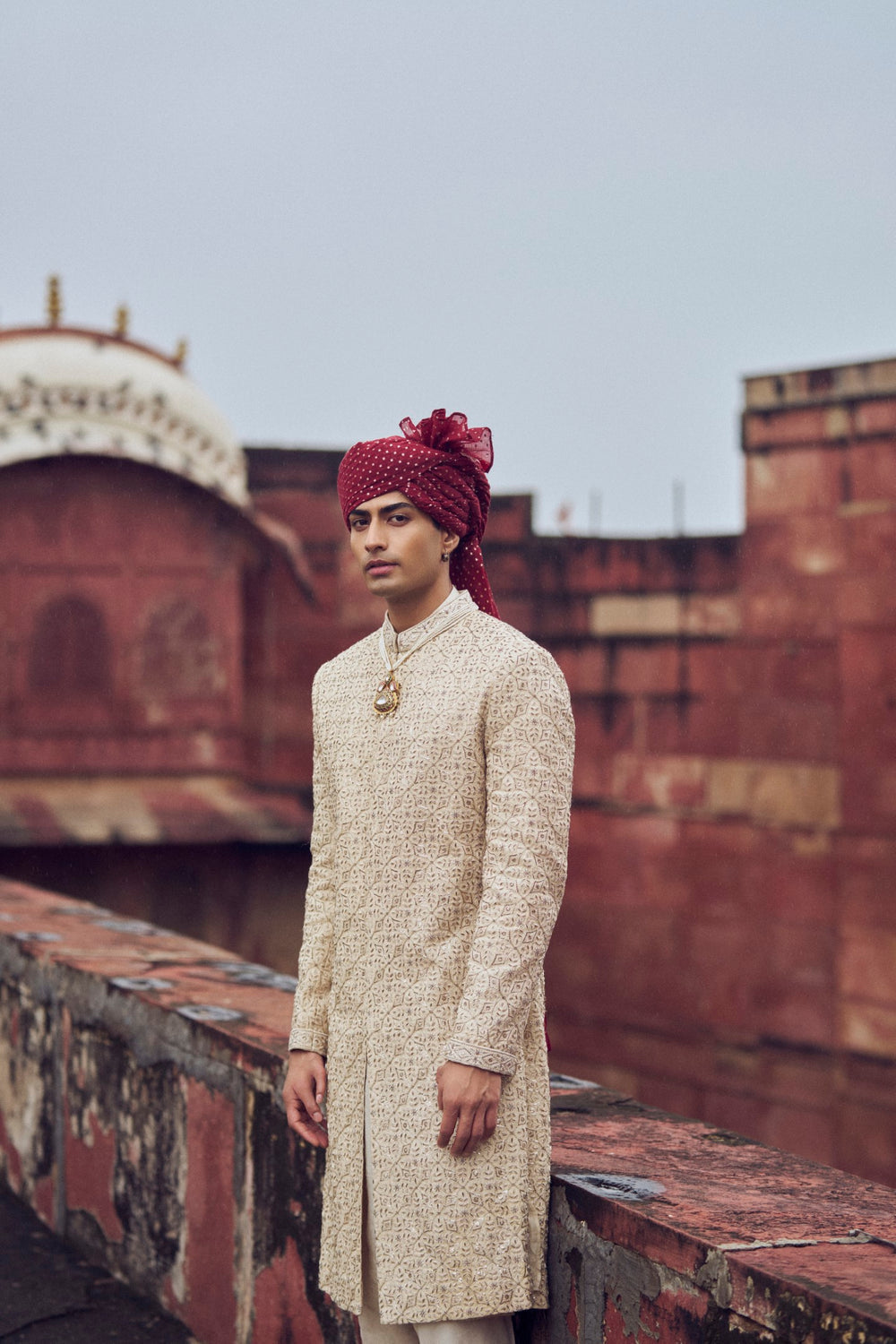 LIGHT BEIGE RAW SILK SHERWANI WITH KURTA AND CHURIDAR. IT COMES WITH AN OPTIONAL BELT, STOLE AND JUTIS
