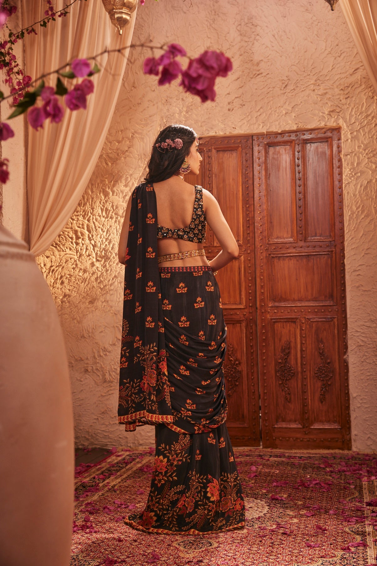 Black Saree Adorned Paired With An Intricately Embroidered Blouse