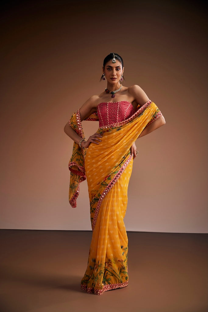Mustard floral saree paired with pink corset