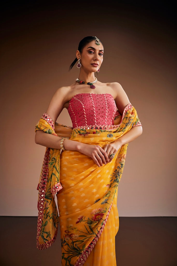 Mustard floral saree paired with pink corset