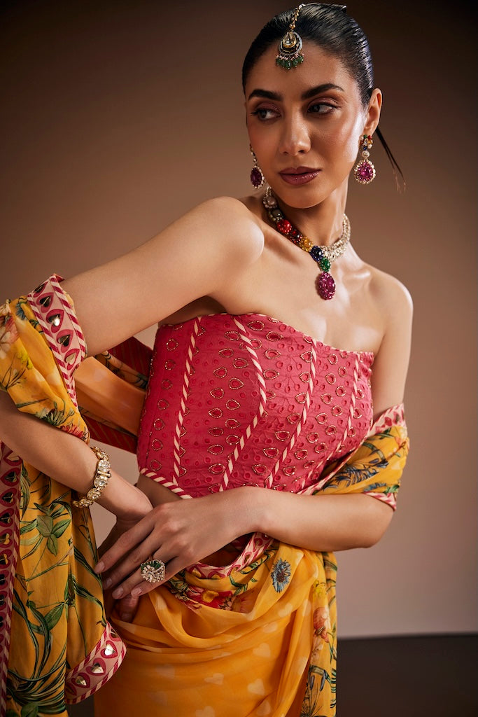 Mustard floral saree paired with pink corset