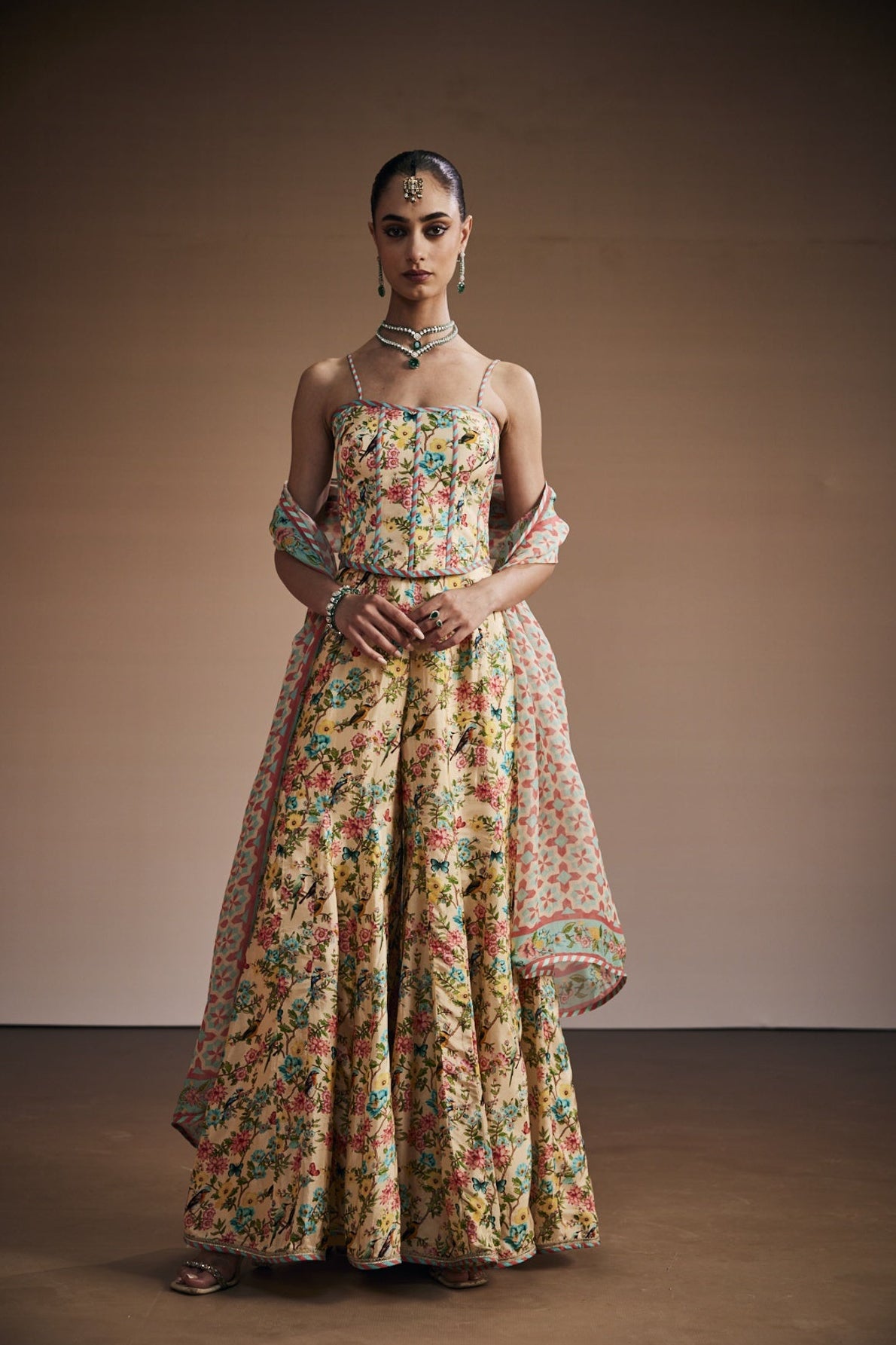 Floral printed corset paired with sharara and dupatta.