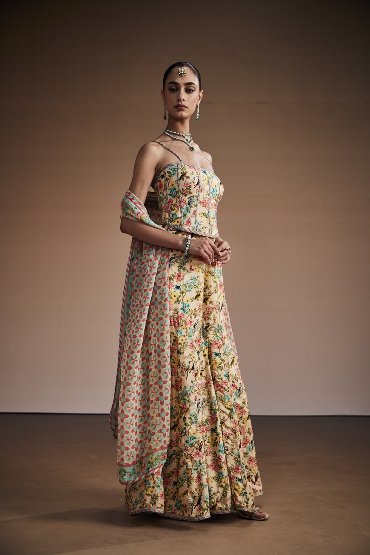 Floral printed corset paired with sharara and dupatta.