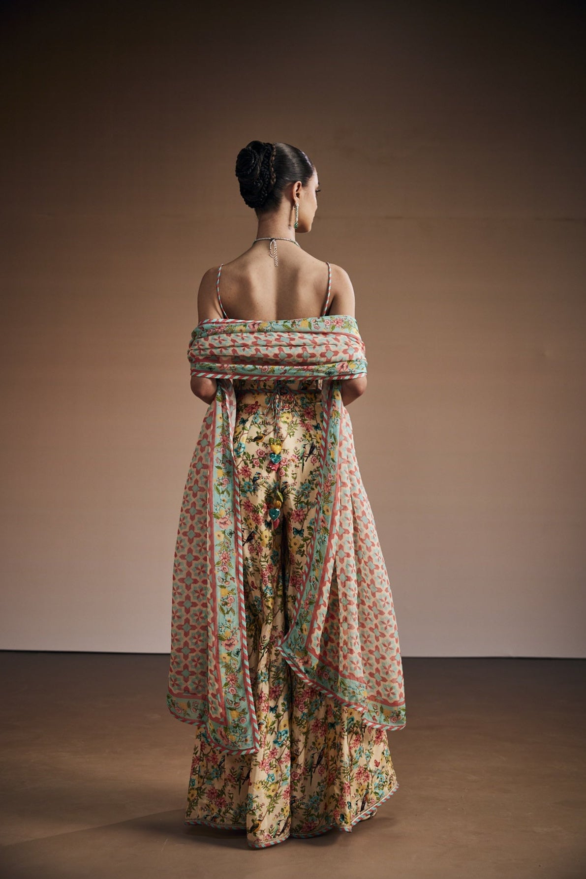 Floral printed corset paired with sharara and dupatta.