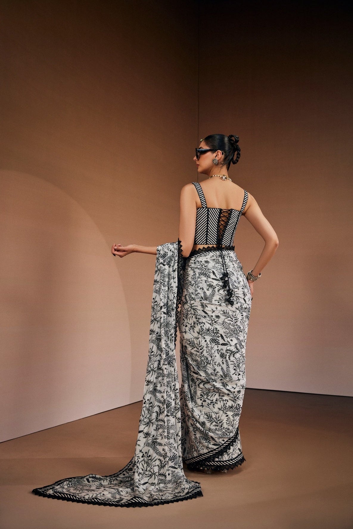 Contemporary printed saree paired with cut-out corset blouse.