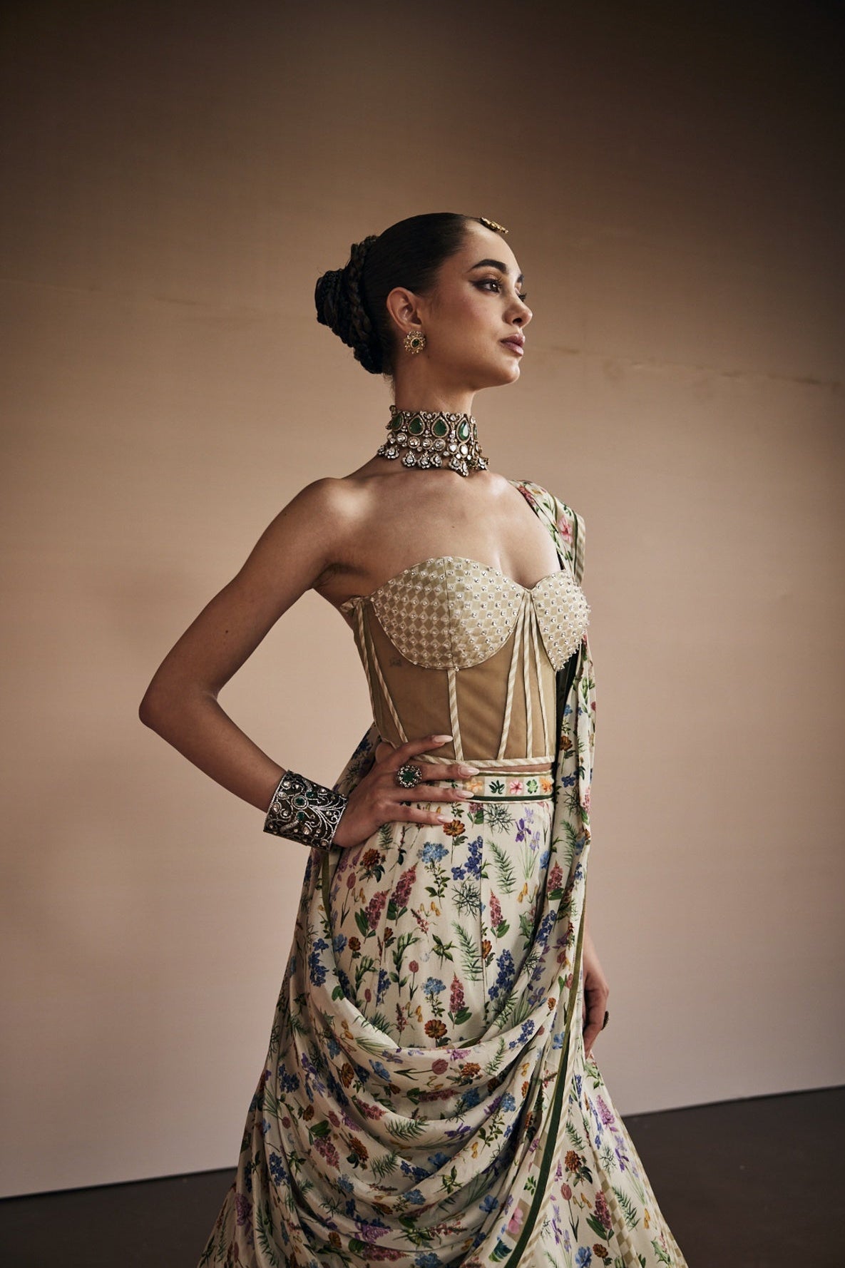 Beige lehenga paired with corset blouse and draped dupatta inspired with checks and floral print