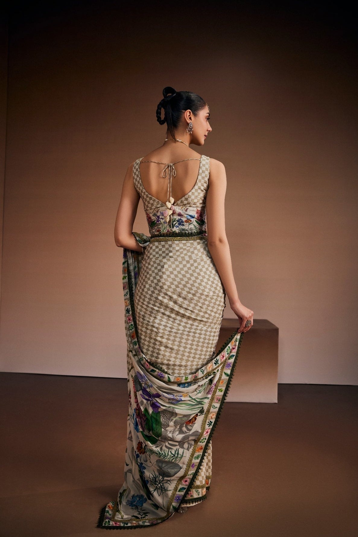 Beige saree inspired with checks and floral prints paired with chic blouse.