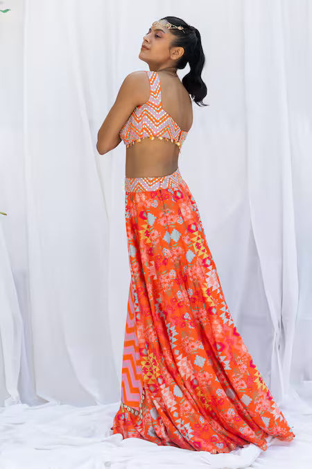 Orange kilim printed lehengas with chevron choli