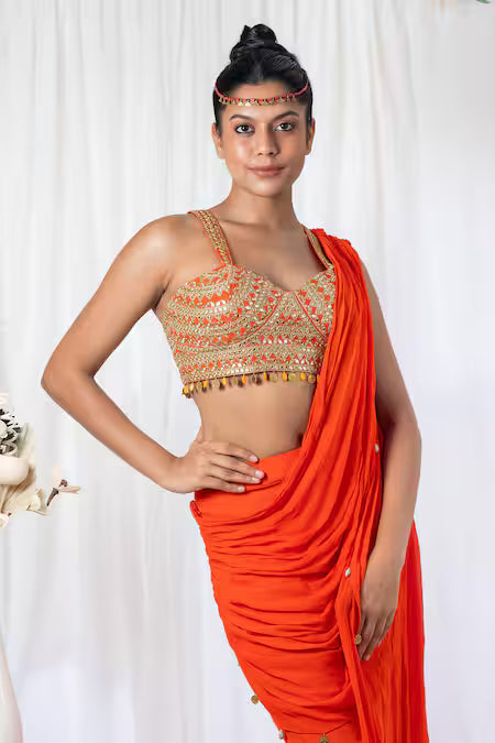 Orange draped saree with mirror work choli