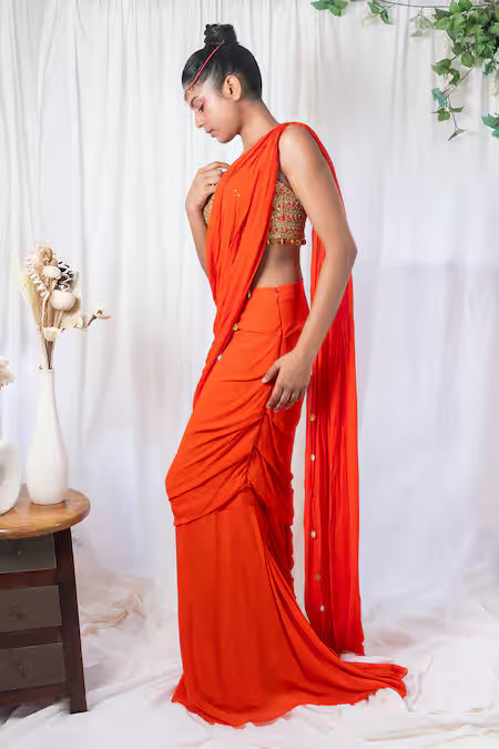 Orange draped saree with mirror work choli