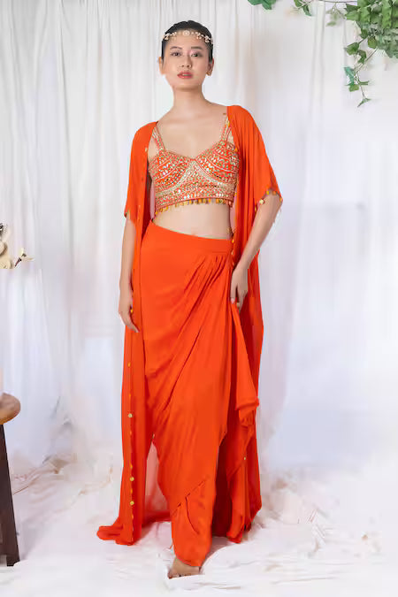 Orange draped saree with mirror work choli and cape