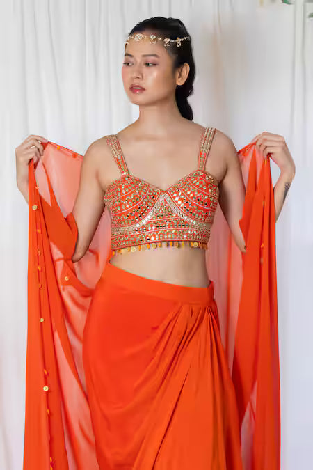 Orange draped saree with mirror work choli and cape