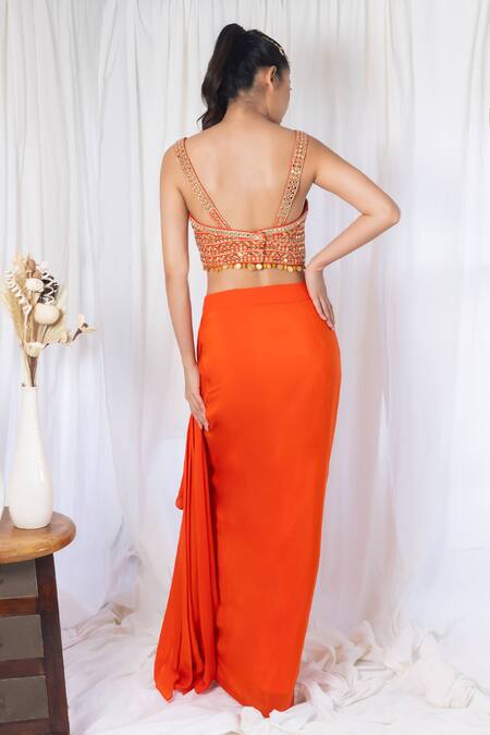 Orange draped saree with mirror work choli and cape