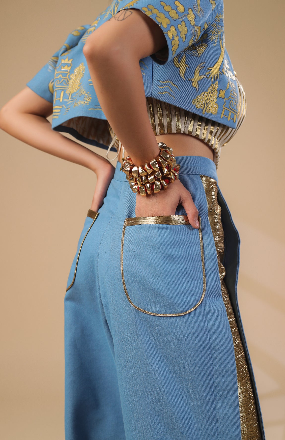 DENIM CROP JACKET WITH GOLD AND IVORY PLEATED CORSET WITH DENIM PANTS