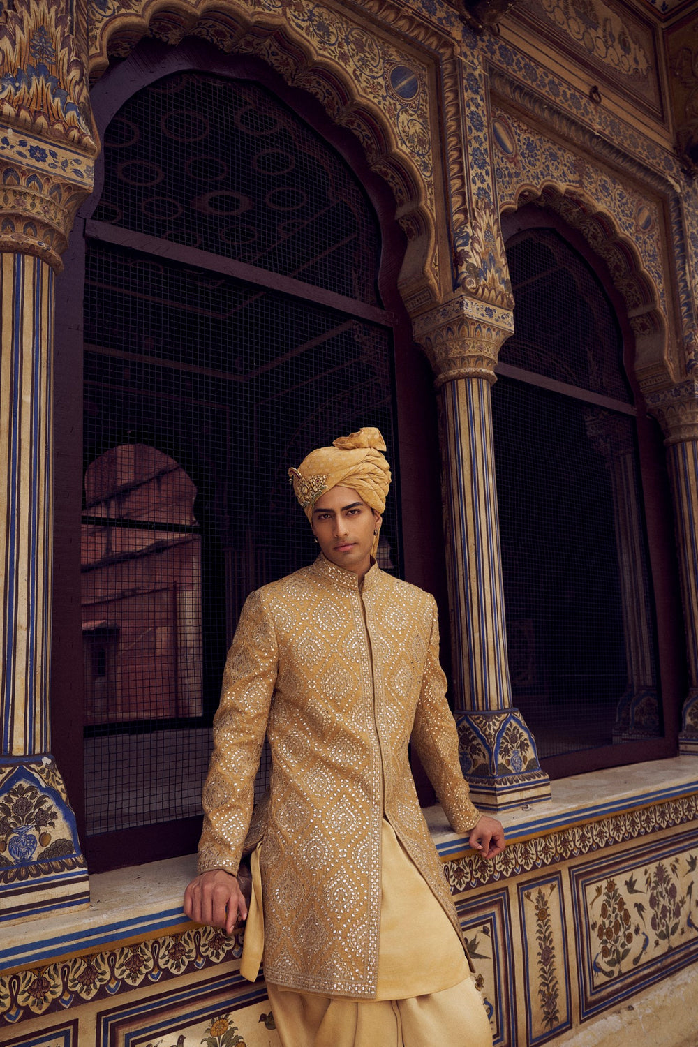 GOLD RAW SILK SHORT SHERWANI WITH A SATIN KURTA AND DHOTI WITH AN OPTIONAL WORKED STOLE AND JUTIS
