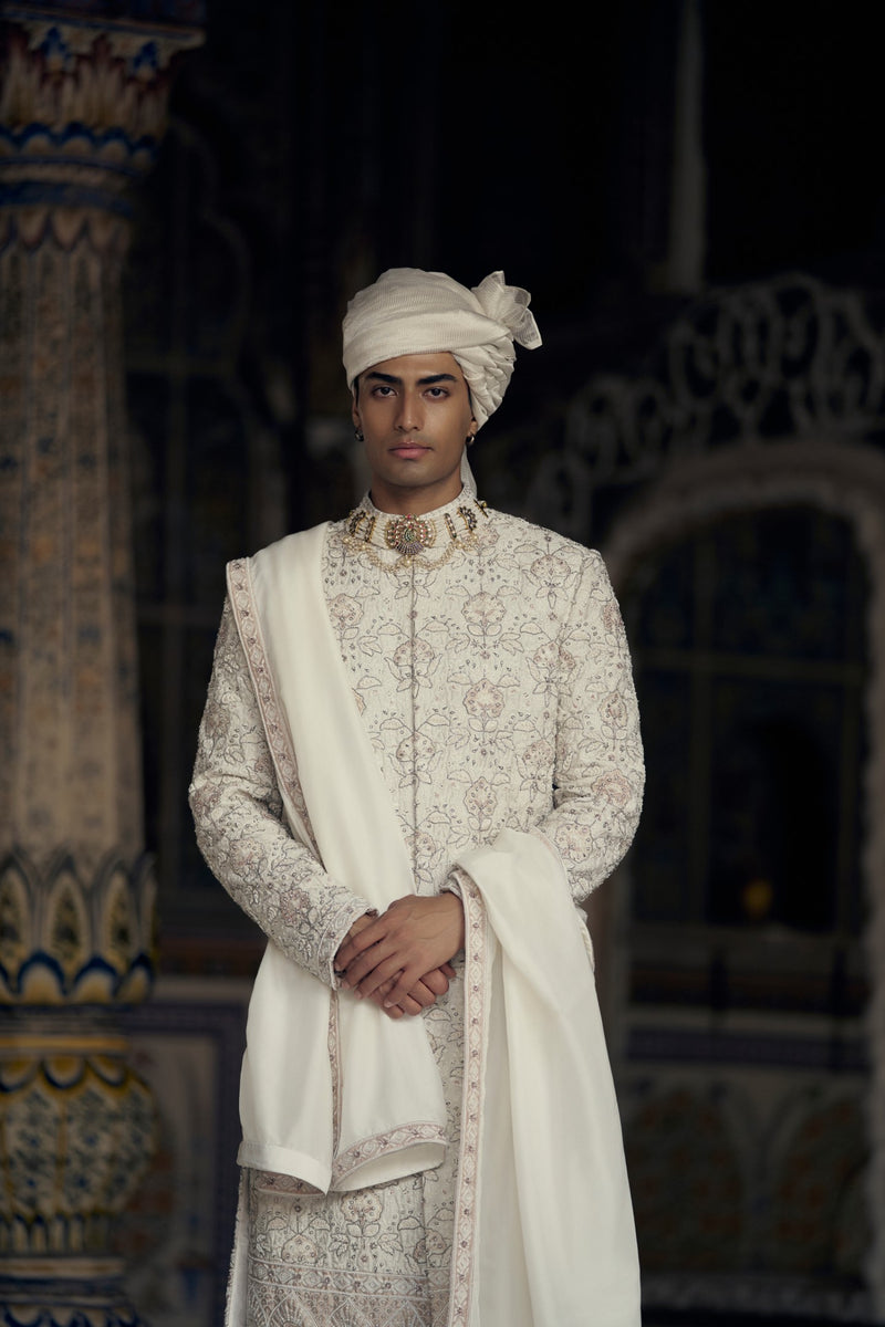 IVORY AND BEIGE RAW SILK SHERWANI SET WITH KURTA AND CHURIDAR AND AN OPTIONAL BELT, STOLE AND JUTIS