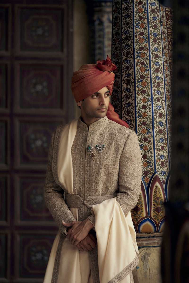 MOCCA RAW SILK SHERWANI WITH KURTA AND CHURIDAR. IT COMES WITH AN OPTIONAL WORKED STOLE, BELT AND JUTTIS