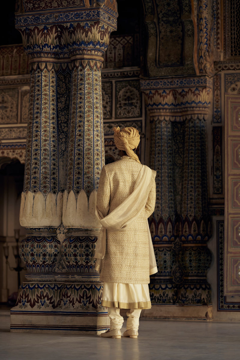 GOLD SHERWANI SET WITH CHOGA AND CHURIDAR WHICH COMES WITH AN OPTIONAL WORKED STOLE AND JUTIS
