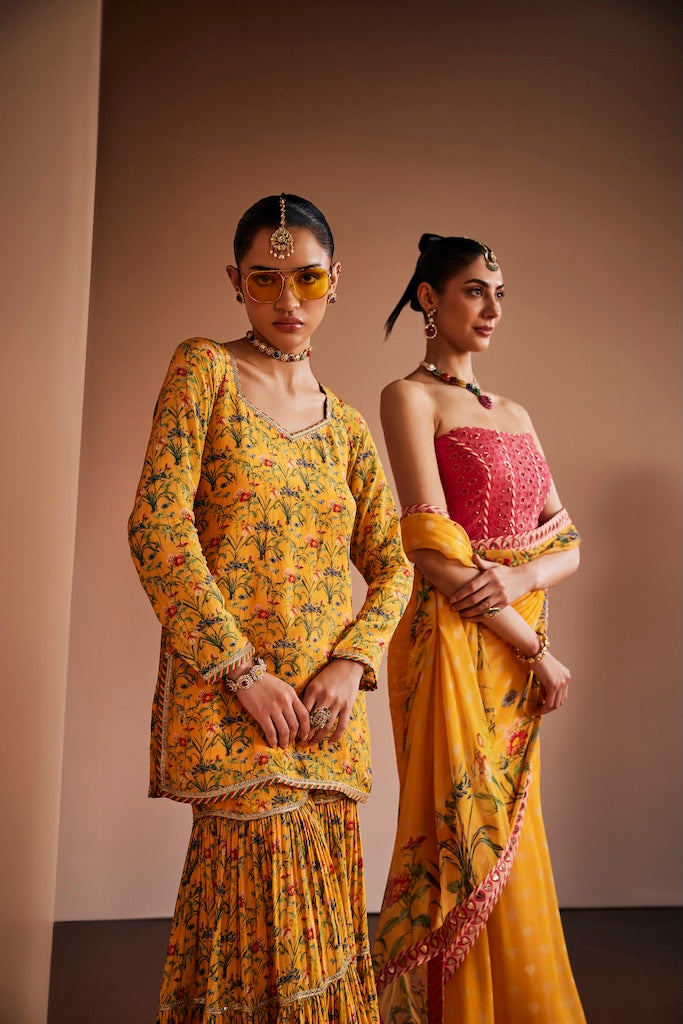 Mustard floral saree paired with pink corset