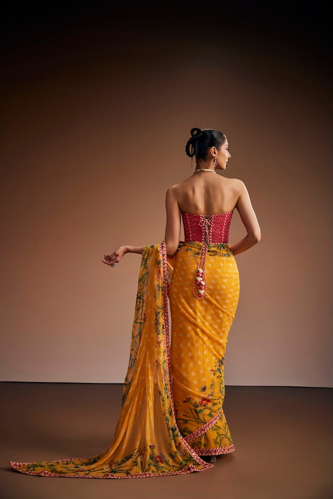 Mustard floral saree paired with pink corset