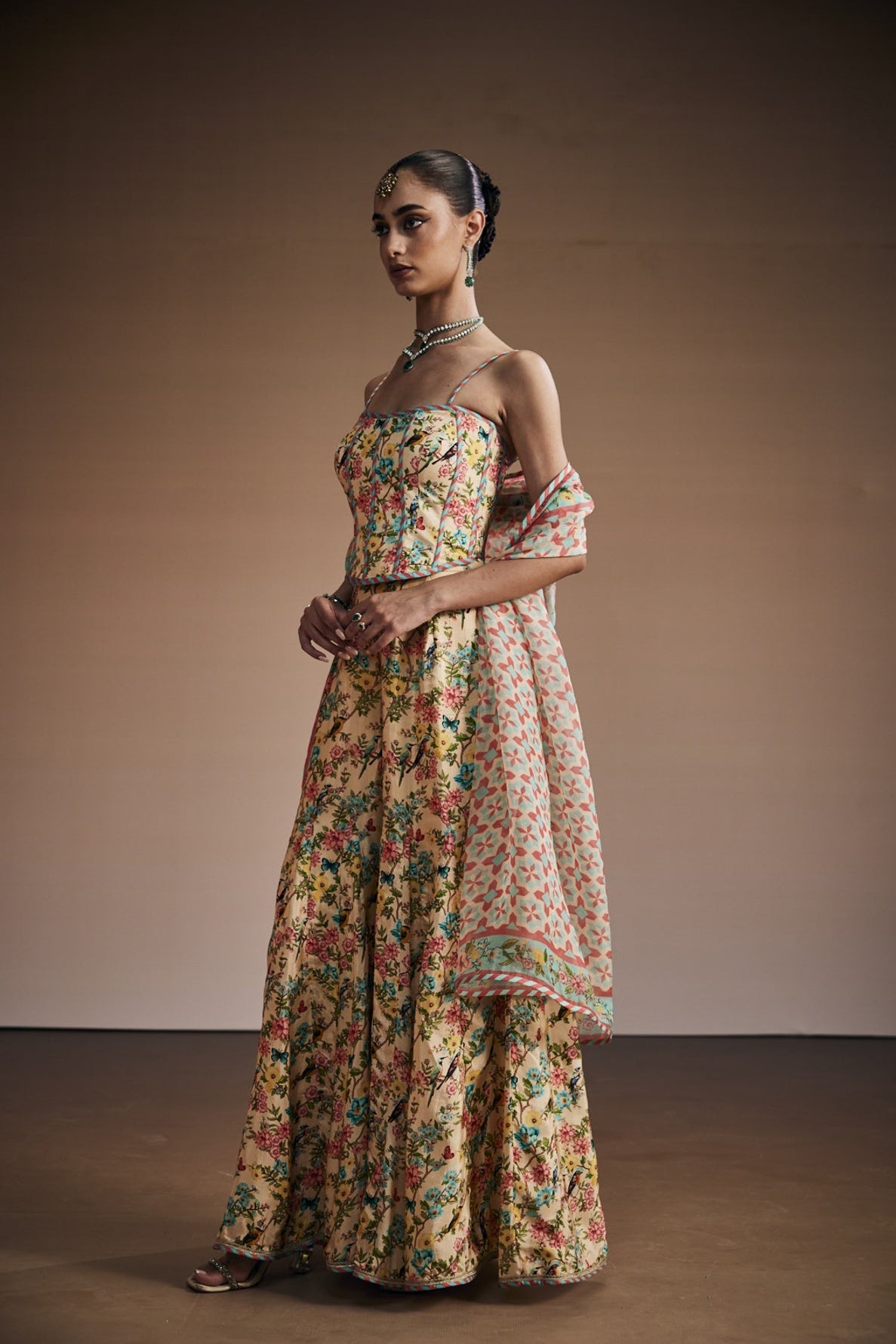 Floral printed corset paired with sharara and dupatta.