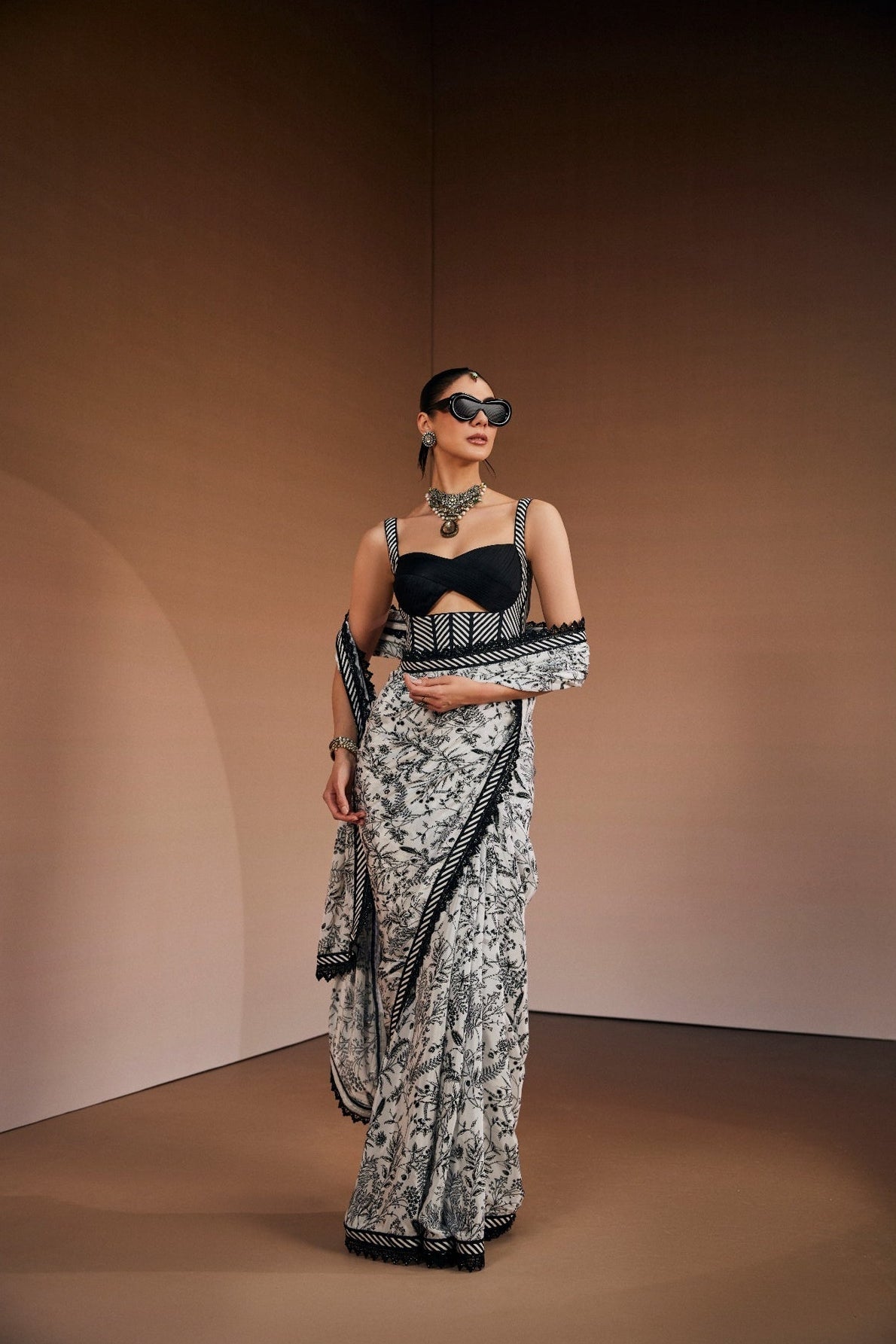 Contemporary printed saree paired with cut-out corset blouse.