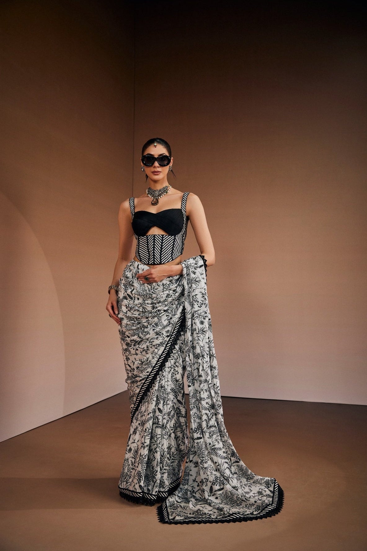 Contemporary printed saree paired with cut-out corset blouse.