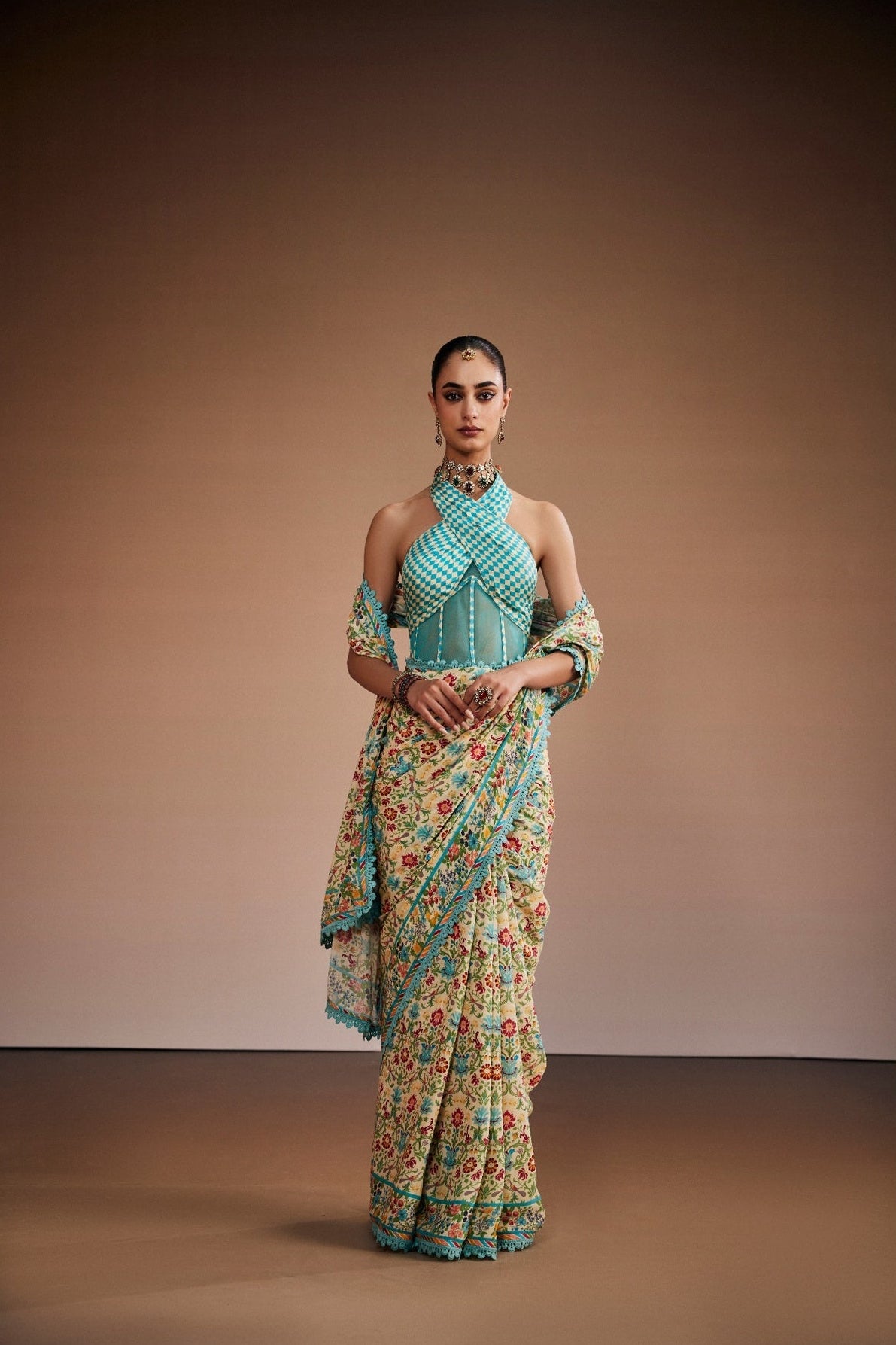 Floral printed saree with stylish corset blouse and border lace.