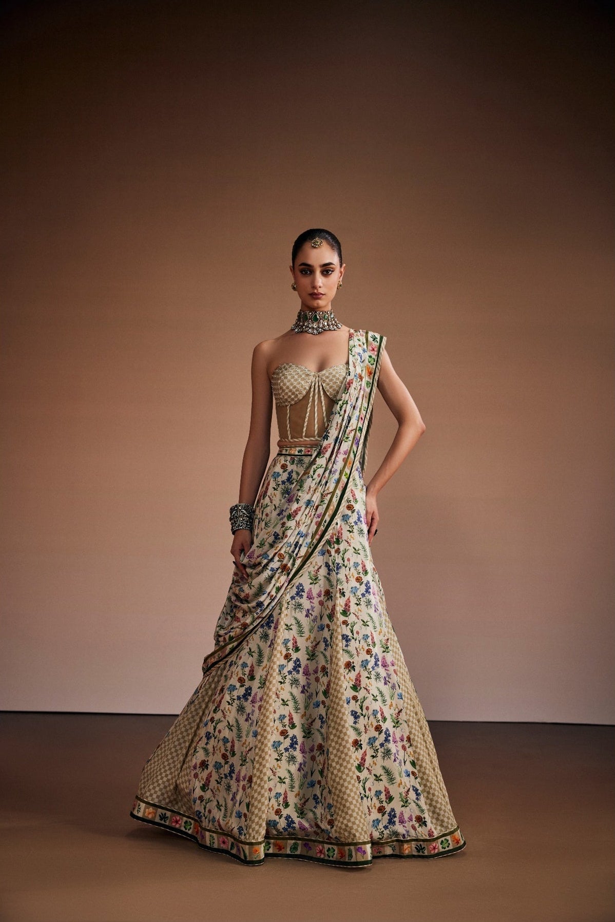 Beige lehenga paired with corset blouse and draped dupatta inspired with checks and floral print
