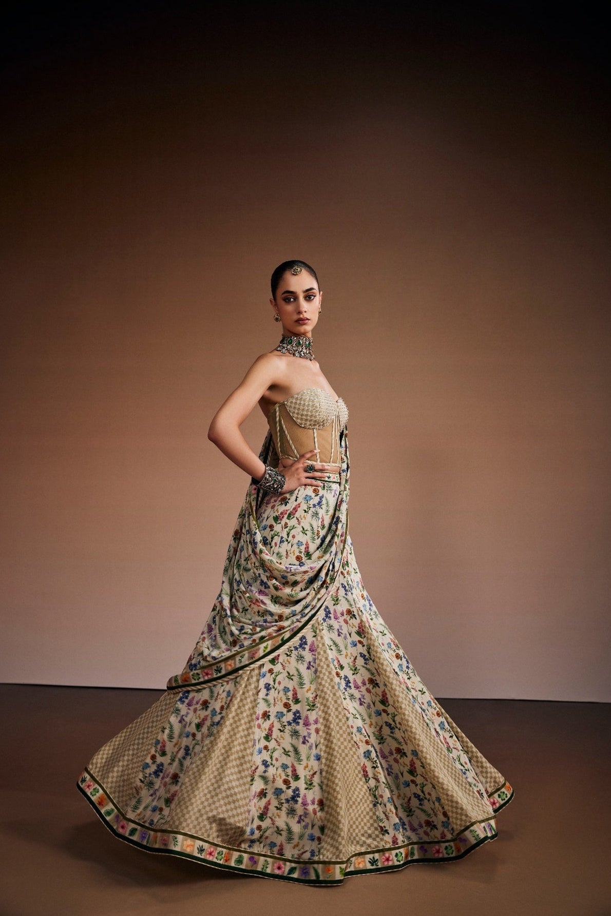 Beige lehenga paired with corset blouse and draped dupatta inspired with checks and floral print