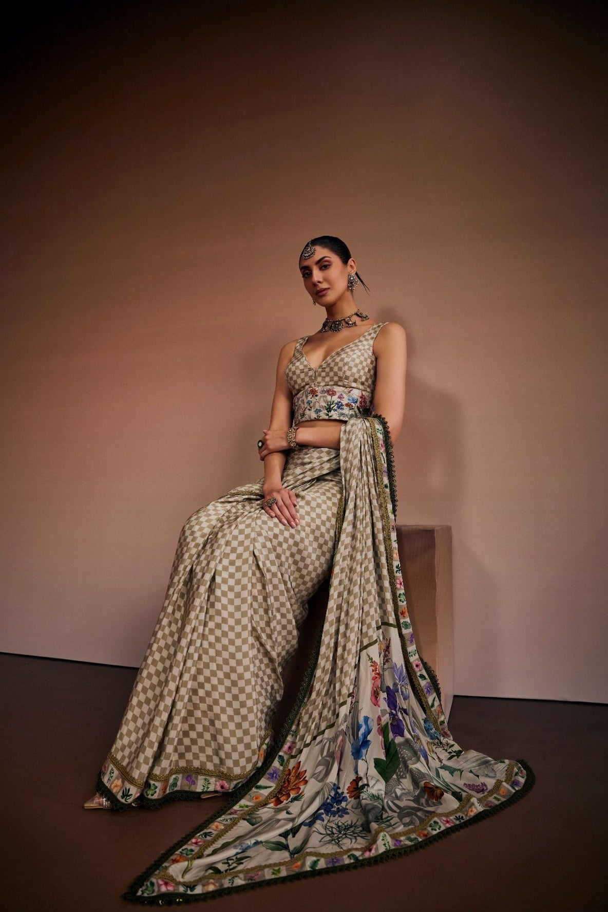 Beige saree inspired with checks and floral prints paired with chic blouse.