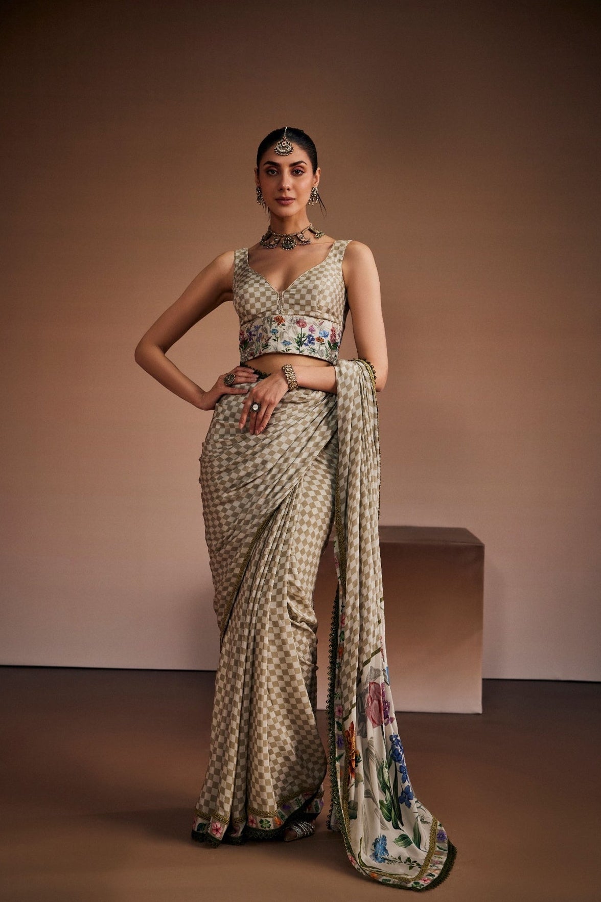 Beige saree inspired with checks and floral prints paired with chic blouse.